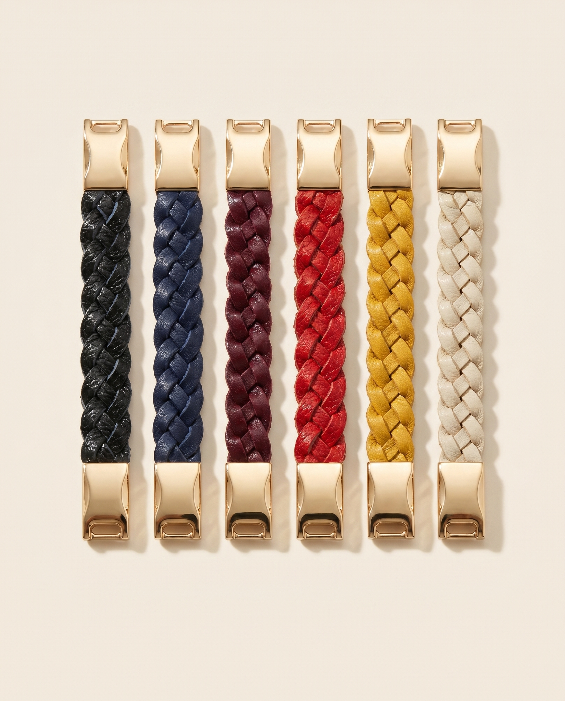 Six braided leather bracelets in black, brown, navy, purple, red and mustard